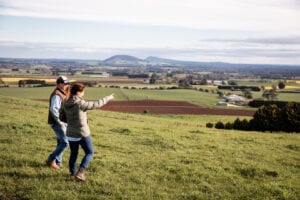Farming couple walking across paddock